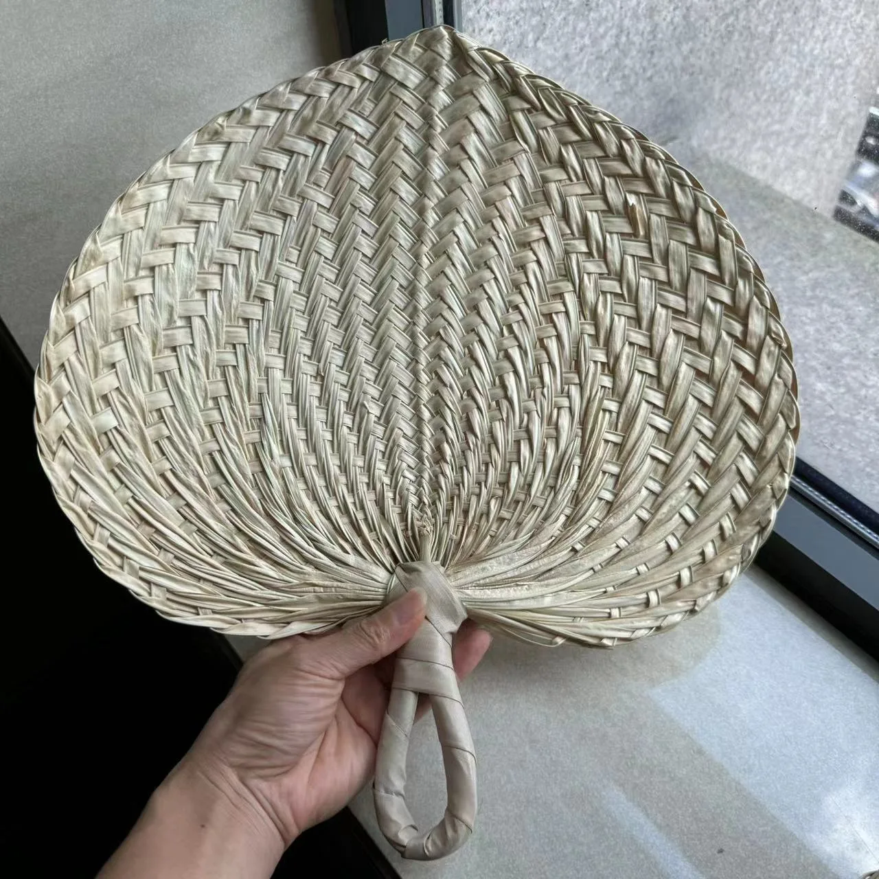 Standard natural woven hand fan before customization
